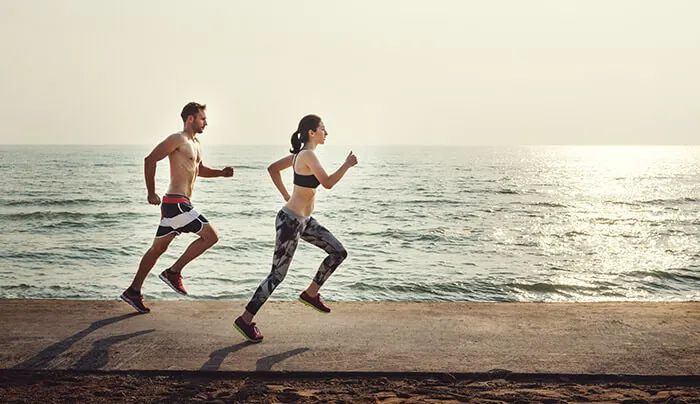 couple jogging by the beach