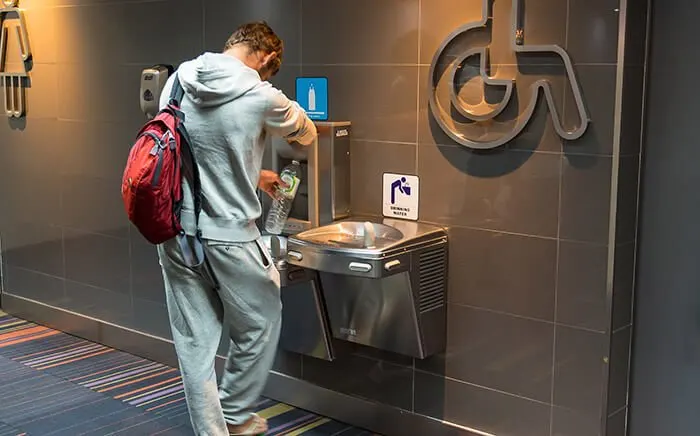 man filling drinking water