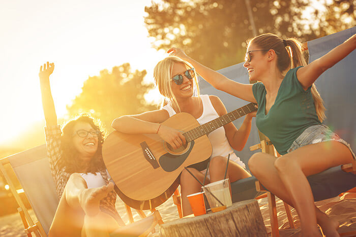 group of friends playing guitar