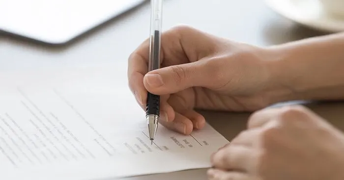 woman signing paper