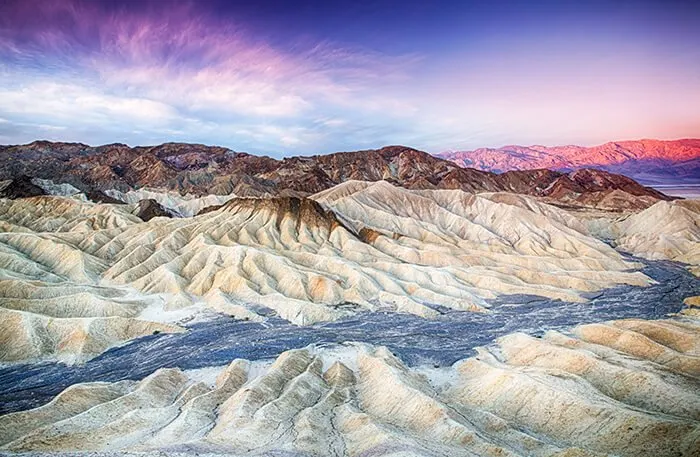 sun rises over Zabriskie Point in Death Valley